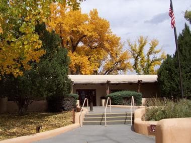 Photo of the historic adobe visitor center in the fall.