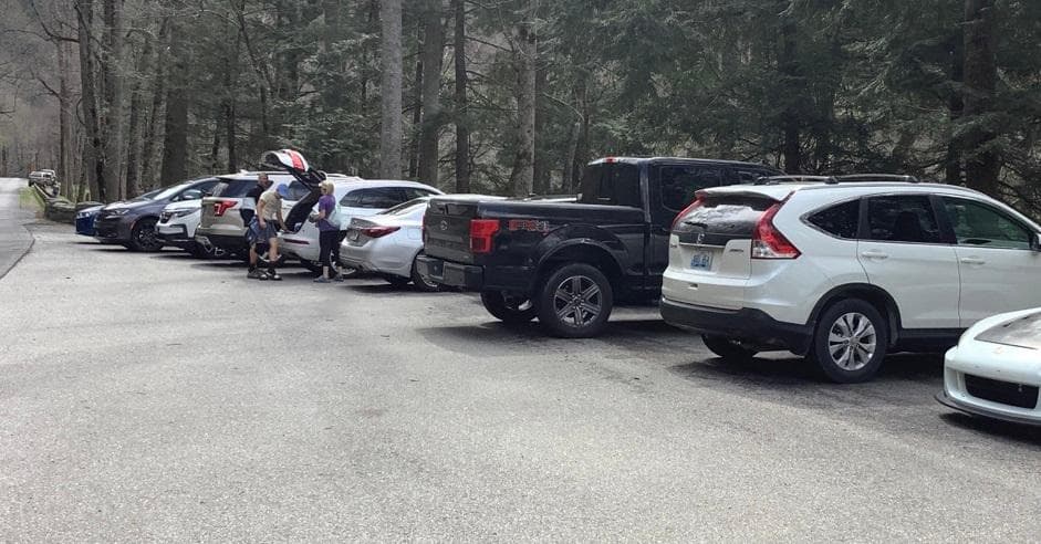 Vehicles parked at Chimney Tops Trailhead Parking Area