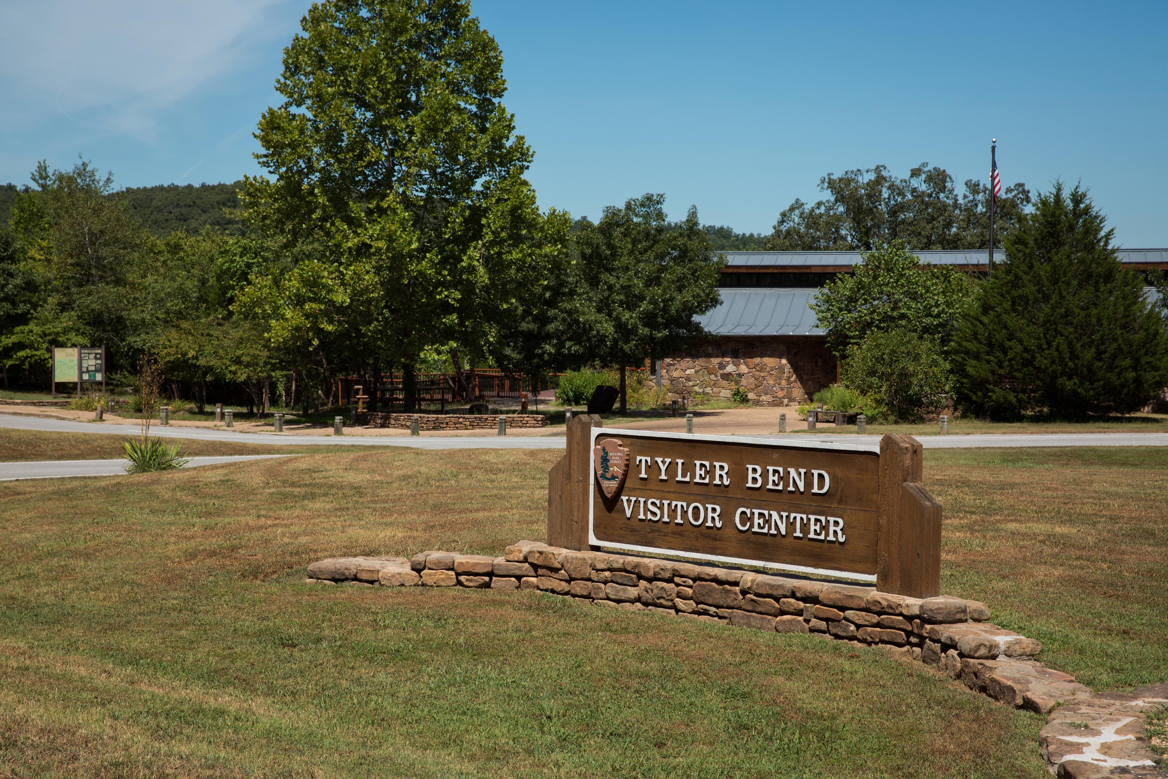 Wood carved signed marking the entrance driveway to the Tyler Bend Visitor Center.