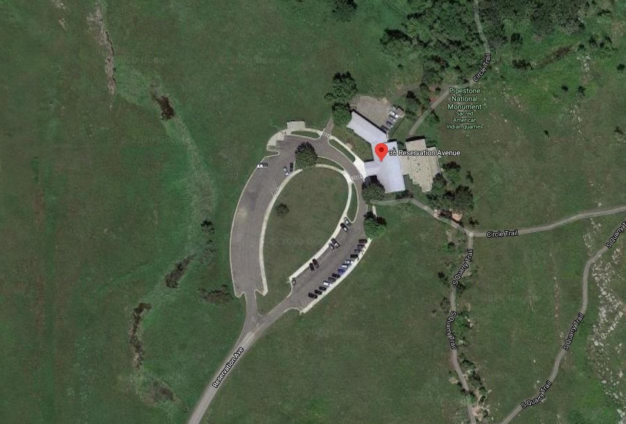 Aerial photo of a teardrop-shaped parking lot surrounded by grass