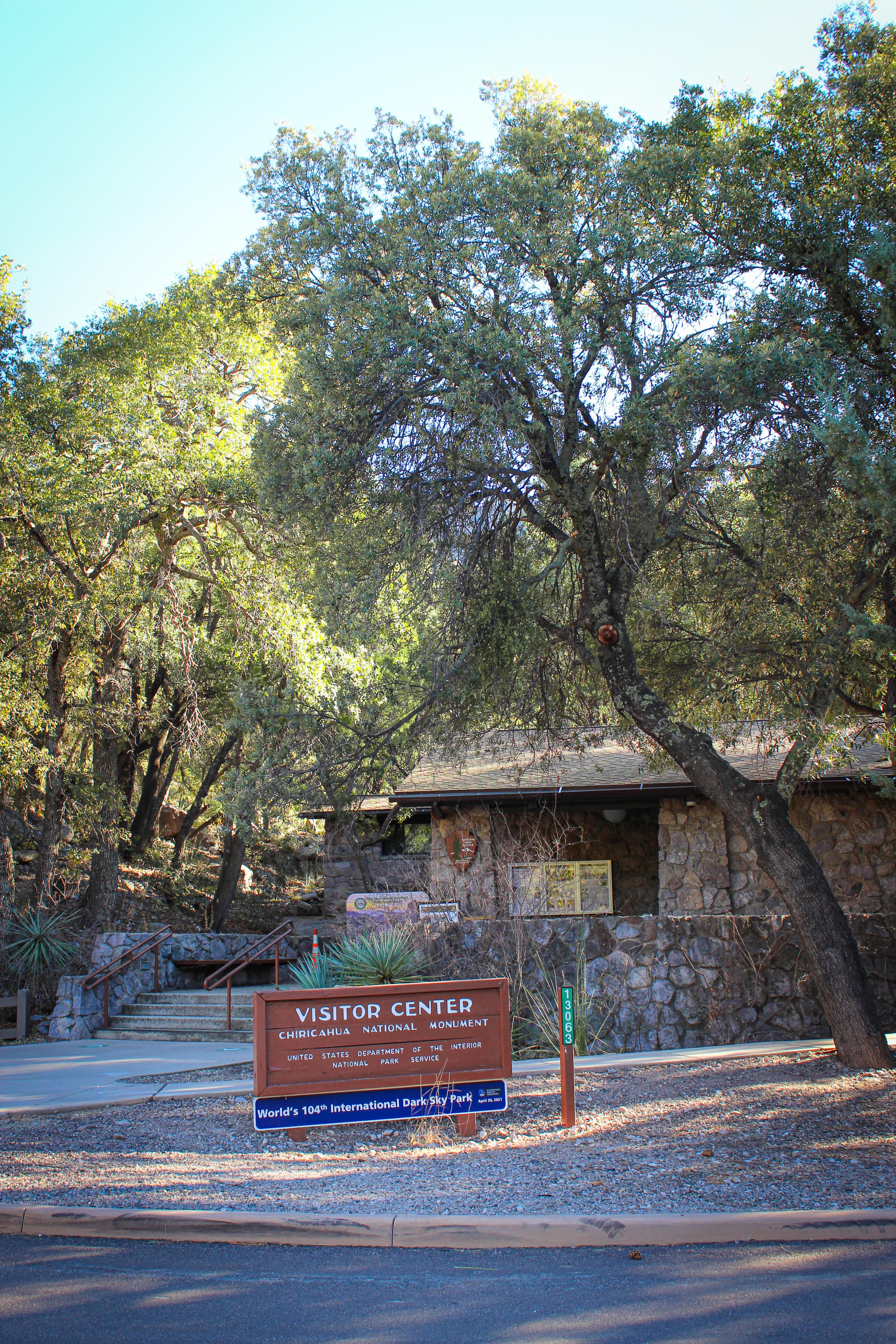 Building made of stone with surrounding trees and mountain peak in background