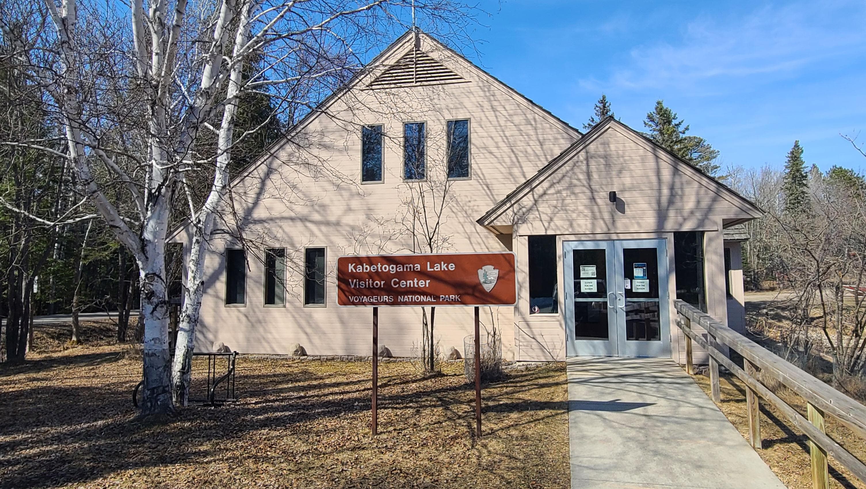 Tan building with a brown sign in front that reads "Kabetogama Lake Visitor Center"