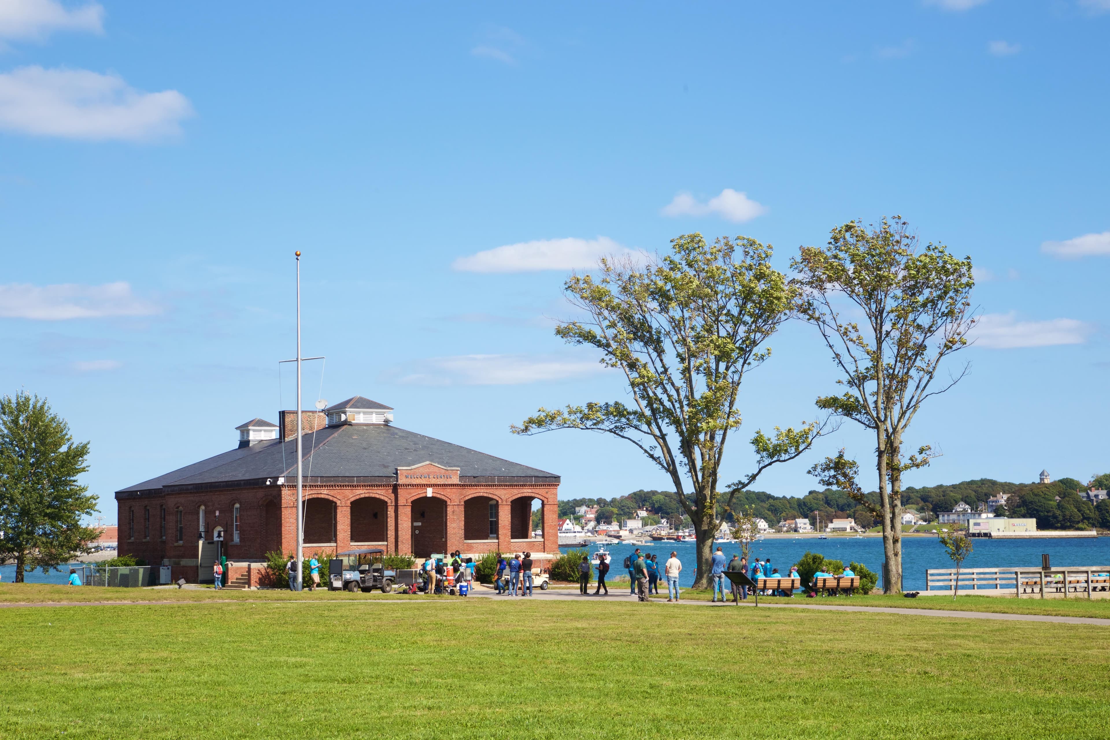green lawn with a brick one-story building in the background.