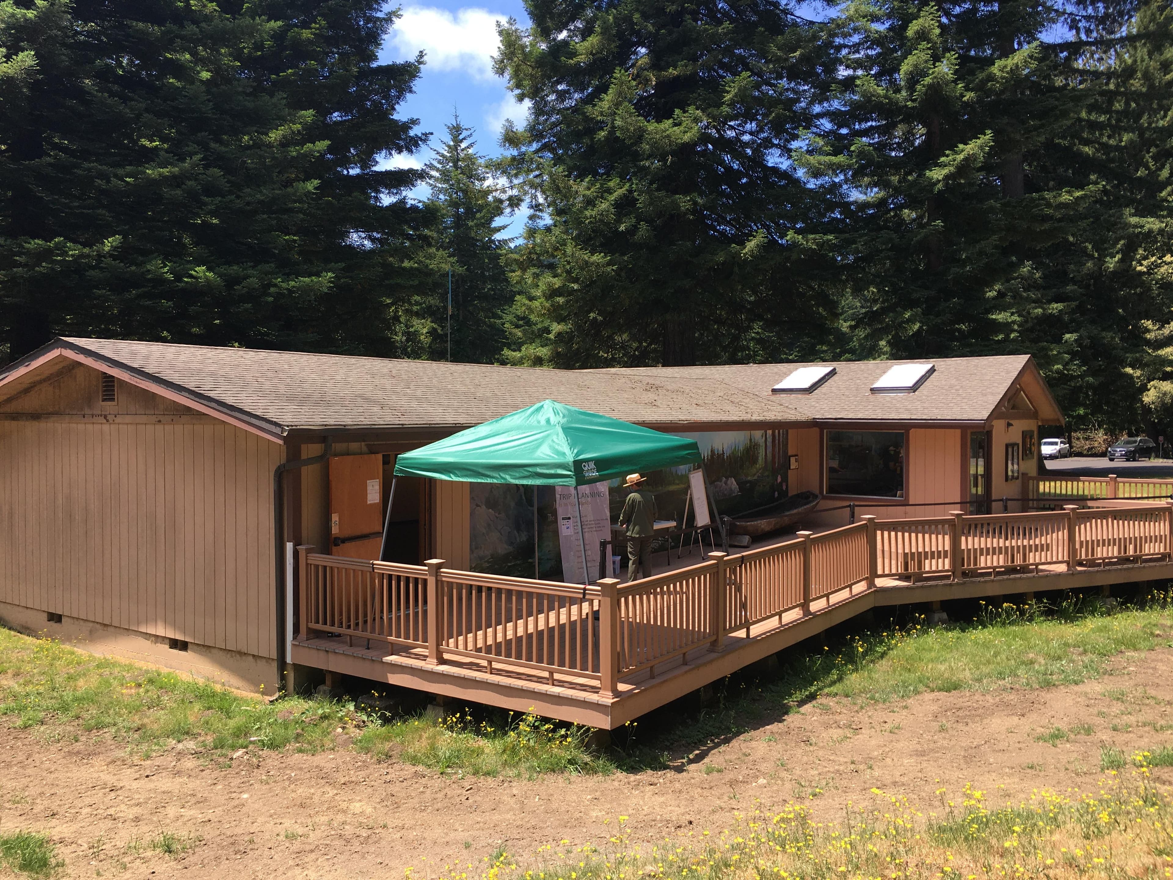 A brown building and a green popup tent