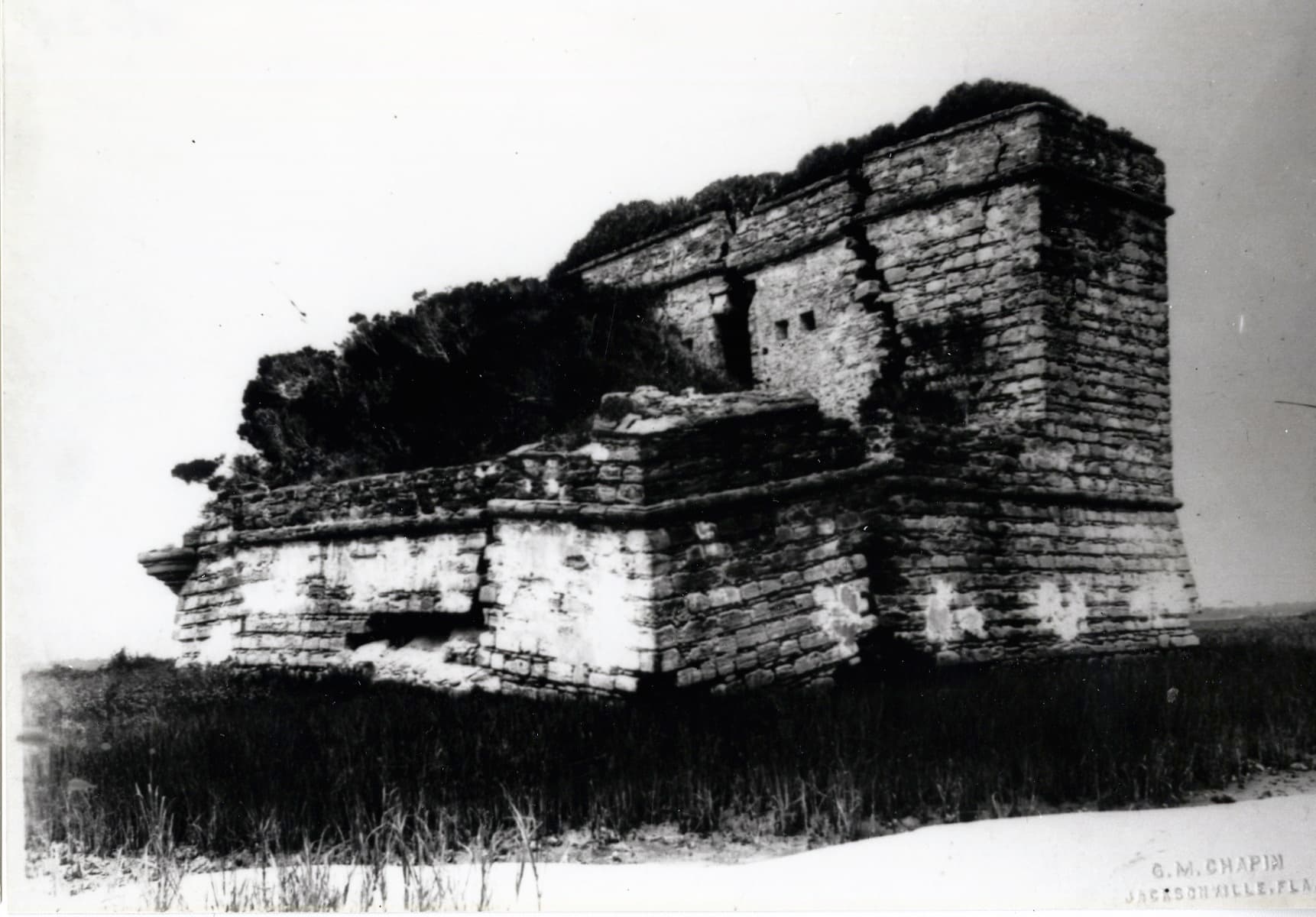 Black and White Photo of Fort Matanzas with many cracks and trees
